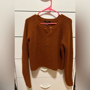 Copper colored knit sweater.